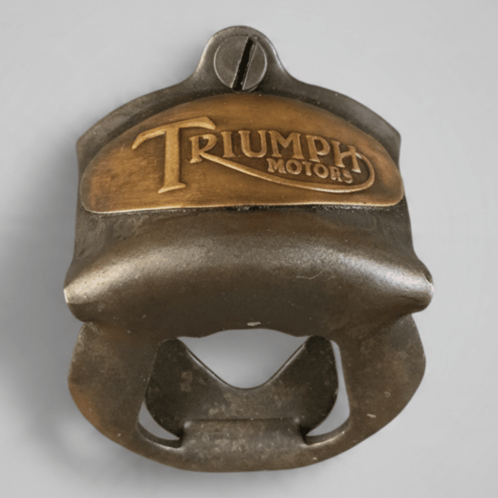Jones Peak Triumph Motorcycles embossed metal wall-mounted bottle opener with an antiqued bronze finish.