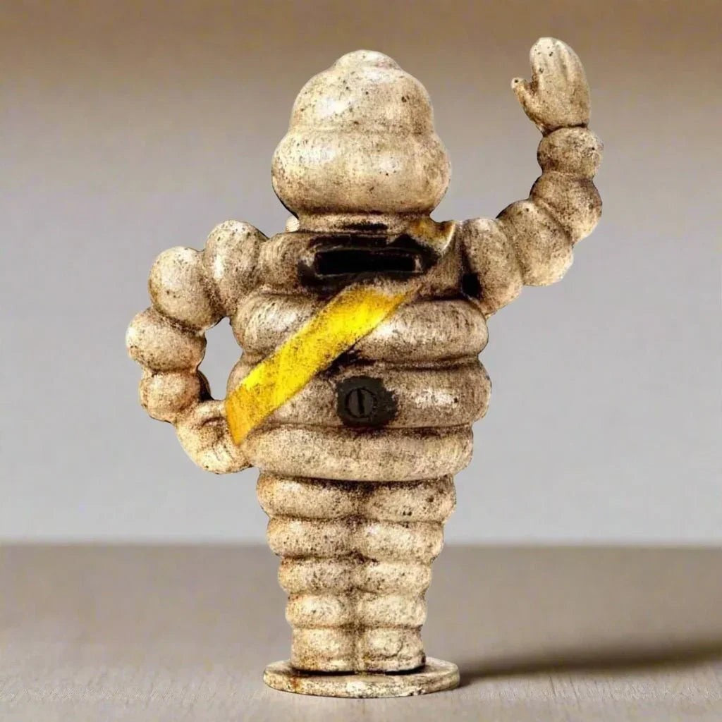 Michelin Man 1889 small cast iron coin bank side view - Jones Peak