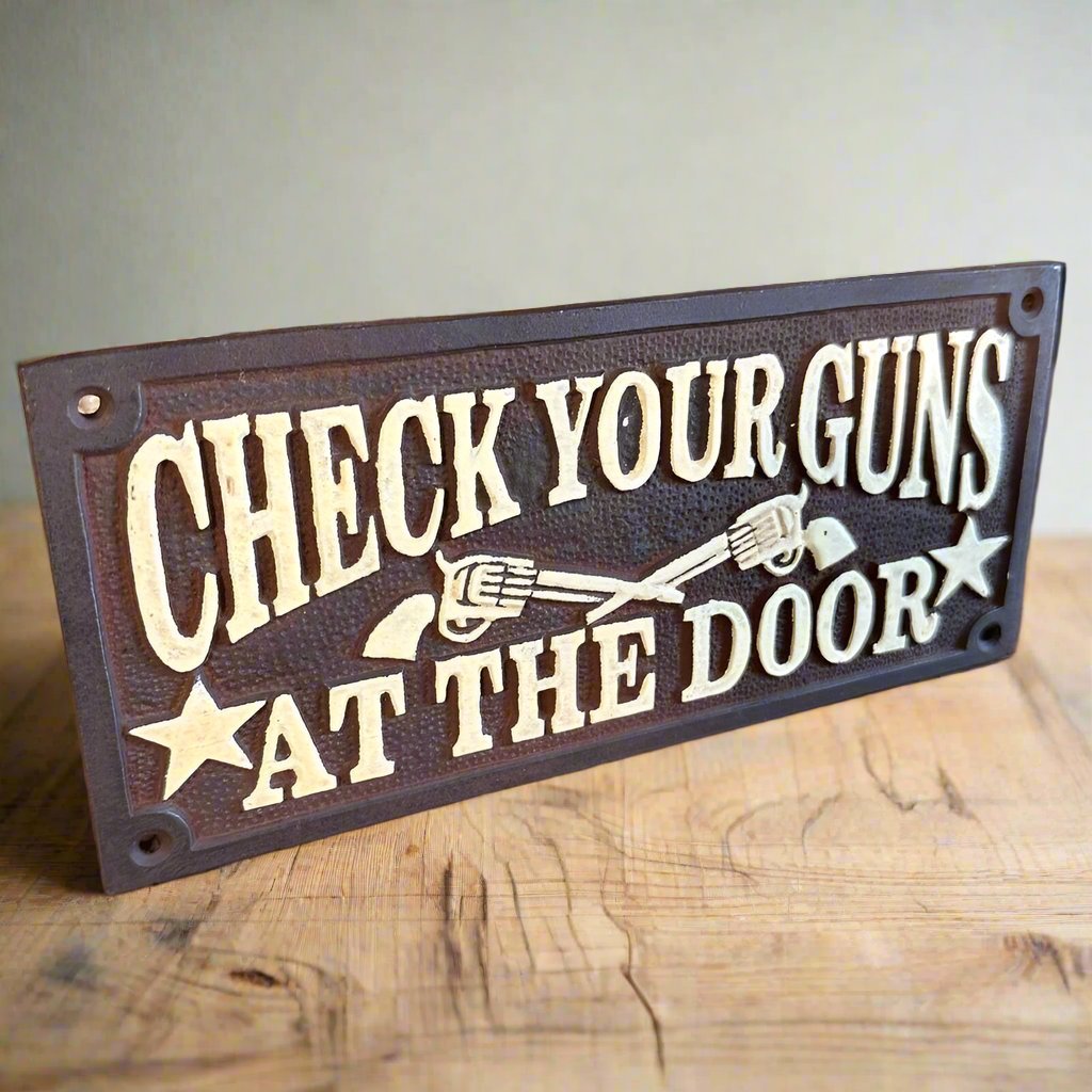 Check Your Guns At The Door Cast Iron Wall Plaque Sign With Antique Finish (7.75" x 3.5") - Jones Peak