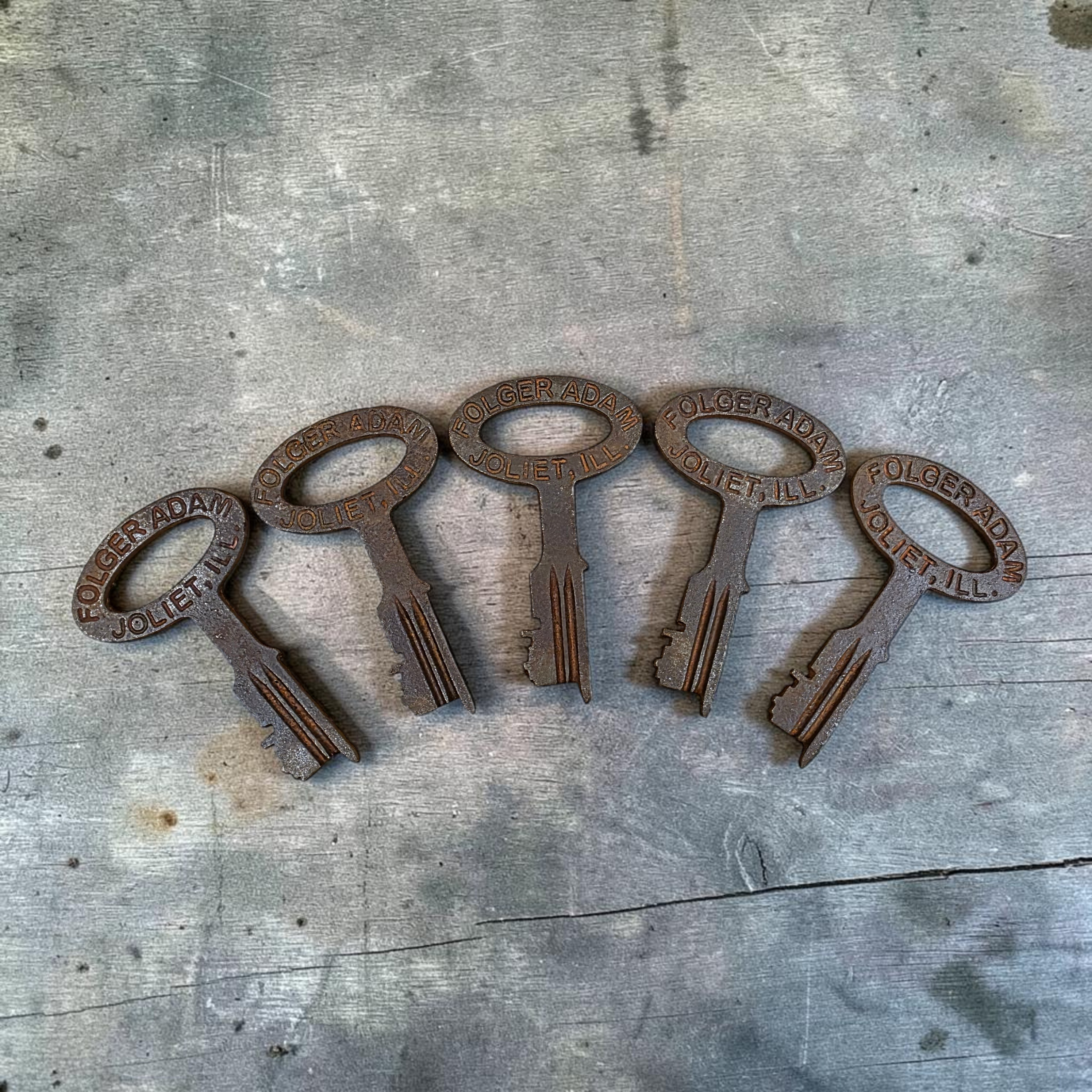 Jones Peak set of five antique-style cast iron jailhouse keys with distressed finish and Folger Adam Joliet lettering