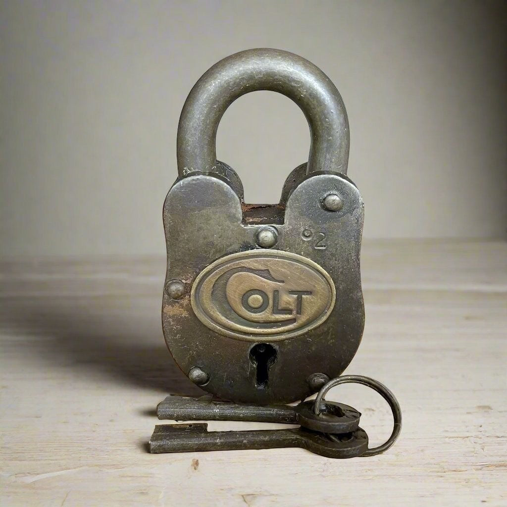 Jones Peak Colt 1855 cast iron padlock with brass tag and two keys, featuring a distressed antique finish.