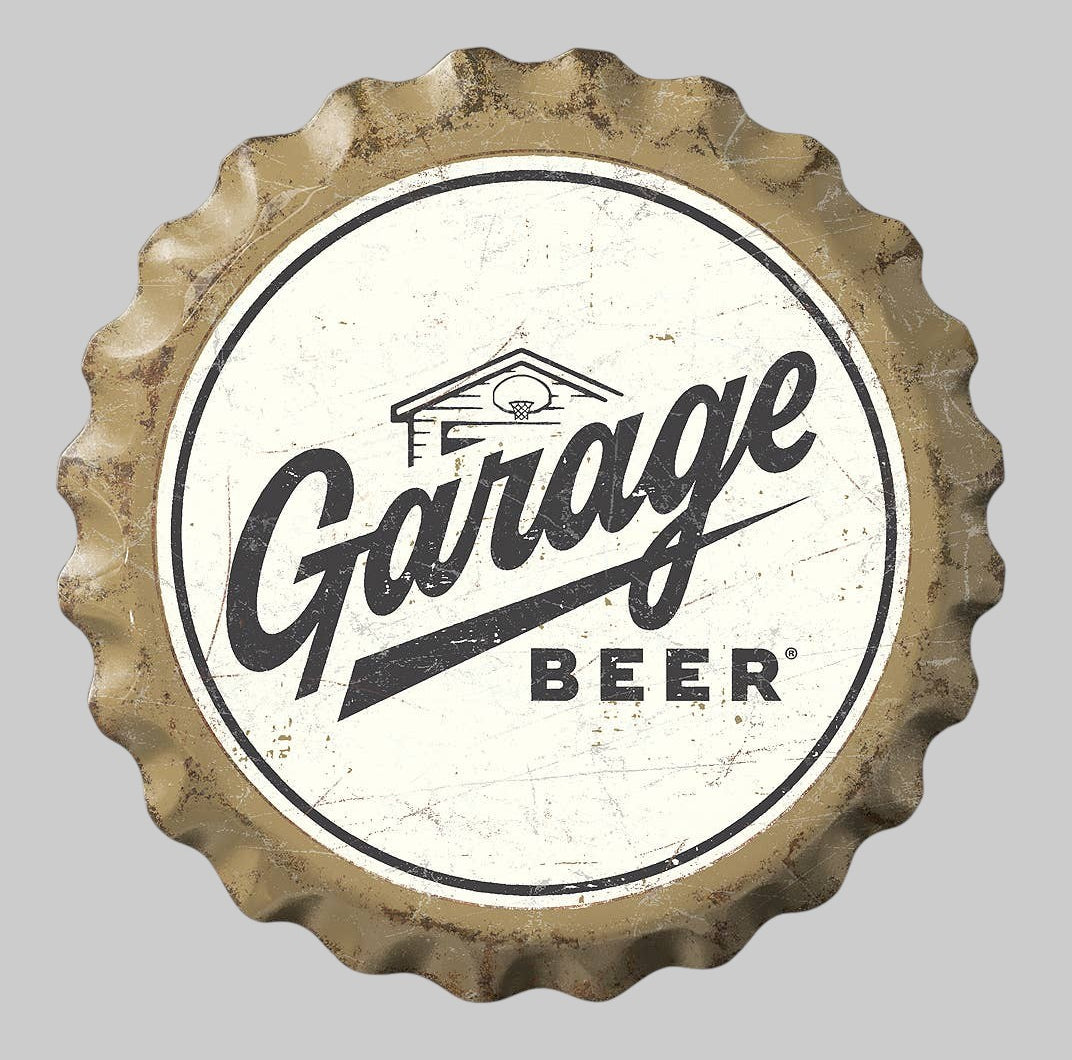 Jones Peak Garage Beer bottle cap metal sign with a cream and black distressed finish and scalloped edge.