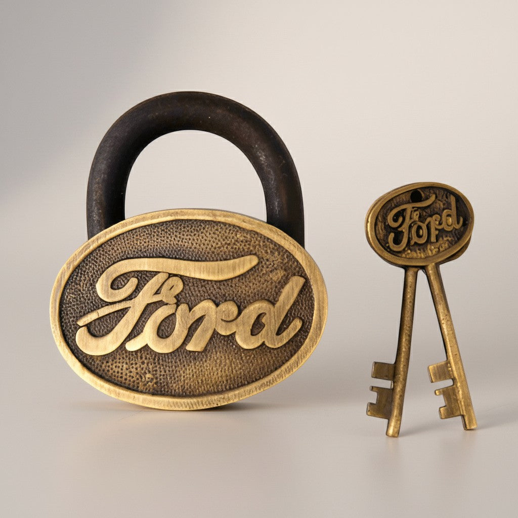 Jones Peak vintage Ford cast iron lock and keys with antique brass finish, oval body, and distressed texture.