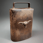 Jones Peak rustic cast iron cow bell featuring a steer head emblem and an antique brown patina finish.