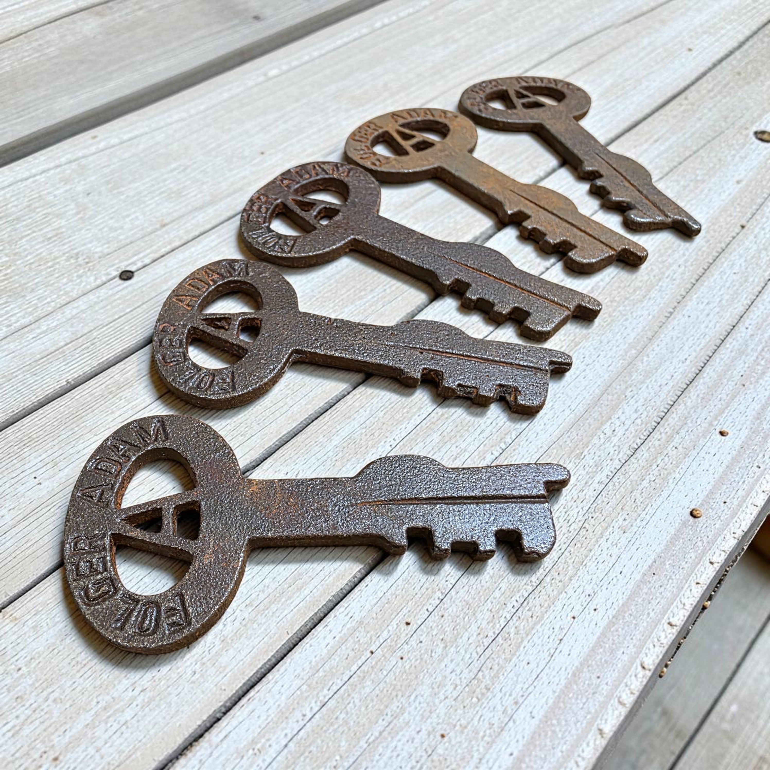 Jones Peak Folger Adams set of five cast iron keys showing distressed antique finish details.