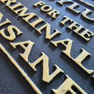 Asylum for the Criminally Insane Cast Iron Embossed Plaque — detail view