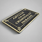 Jones Peak cast iron Asylum for the Criminally Insane plaque with an antique finish and raised gold lettering.