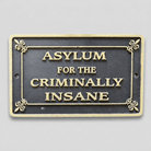 Jones Peak cast iron plaque with antique finish reading Asylum for the Criminally Insane with embossed gold lettering.