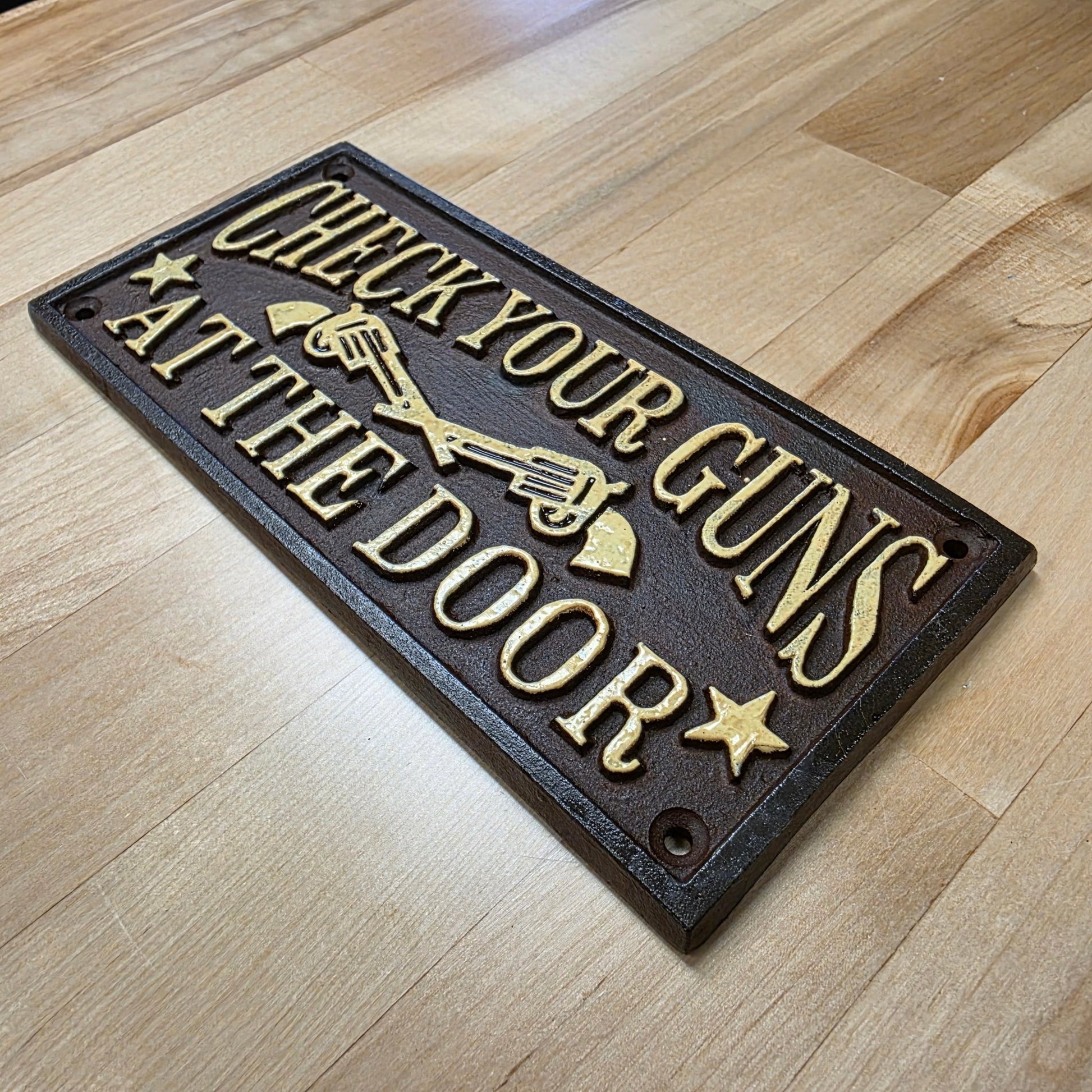 Check Your Guns At The Door Cast Iron Wall Plaque Sign With Antique Finish (7.75" x 3.5") - Jones Peak