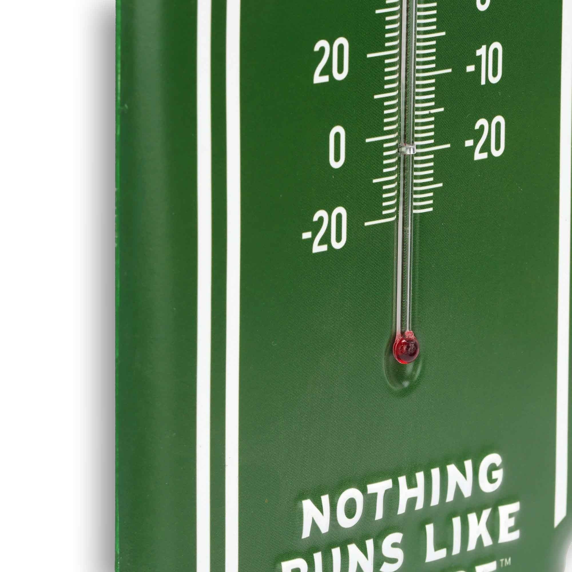 Close-up of John Deere Farm Equipment wall thermometer showing the temperature tube and Fahrenheit and Celsius scales