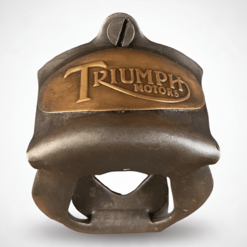 Jones Peak Triumph Motorcycles embossed metal wall-mounted bottle opener with an antiqued bronze finish.