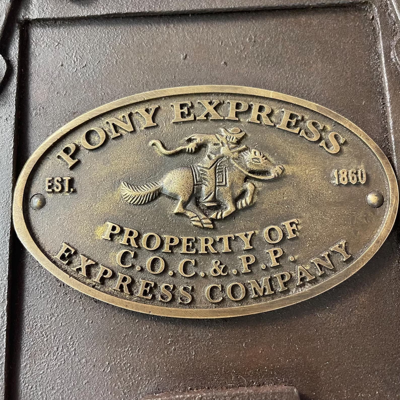 Antique finish cast iron strong box by Great Western, featuring a brass tag, measuring 10"x8"x7".