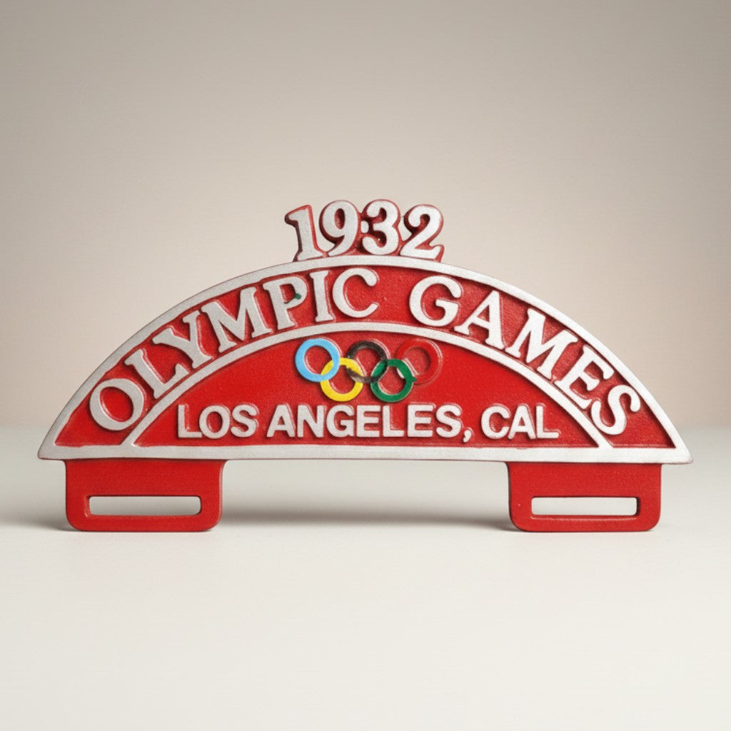 Jones Peak 1932 Los Angeles Olympic Games license plate topper, red aluminum with antique patina finish and Olympic rings.