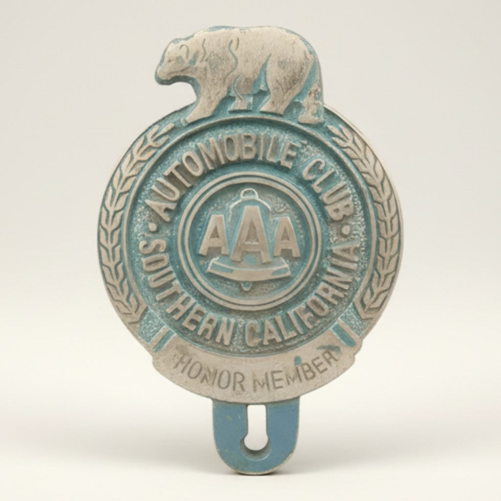 Jones Peak Automobile Club 1902 Bear FOB License Plate Topper, aluminum with antique patina finish, features a bear and AAA logo.