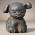 Jones Peak cast iron puppy paperweight with an antique distressed finish, 1.5" tall.