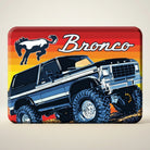 Jones Peak Ford Bronco retro magnet featuring a dark blue lifted Bronco with large tires on a colorful sunset background.