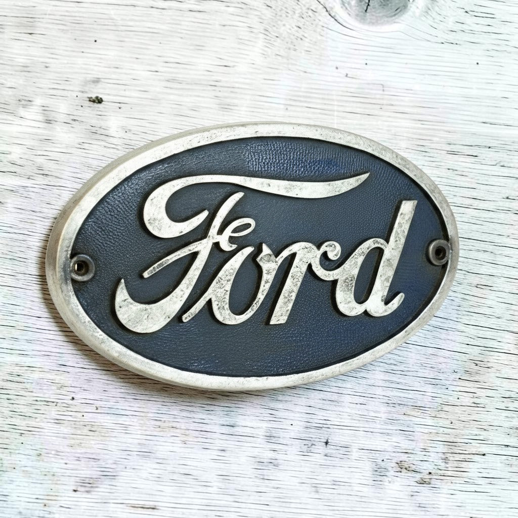 Jones Peak Ford 1903 cast iron plaque with raised details and antique finish. Dark blue background.
