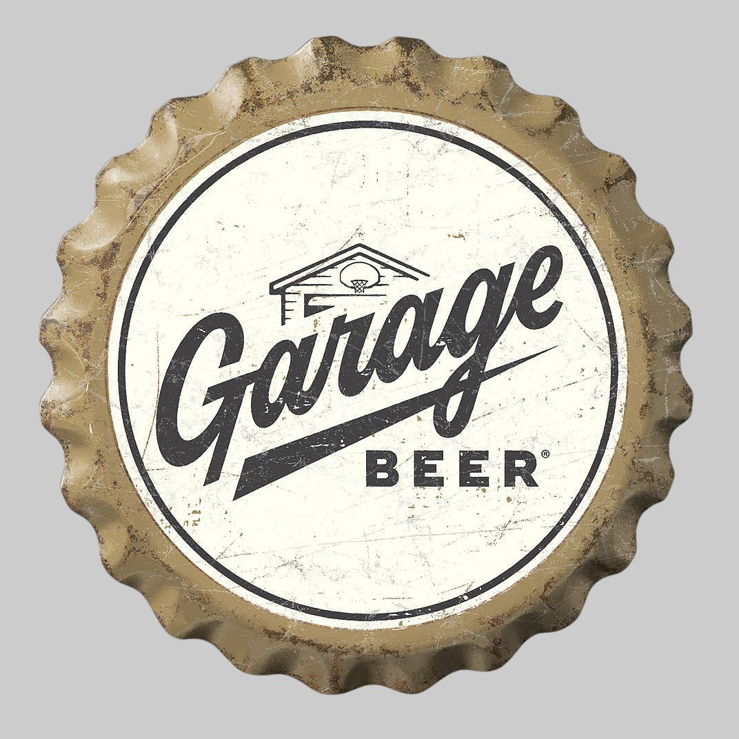 Jones Peak Garage Beer bottle cap metal sign with a cream and black distressed finish and scalloped edge.