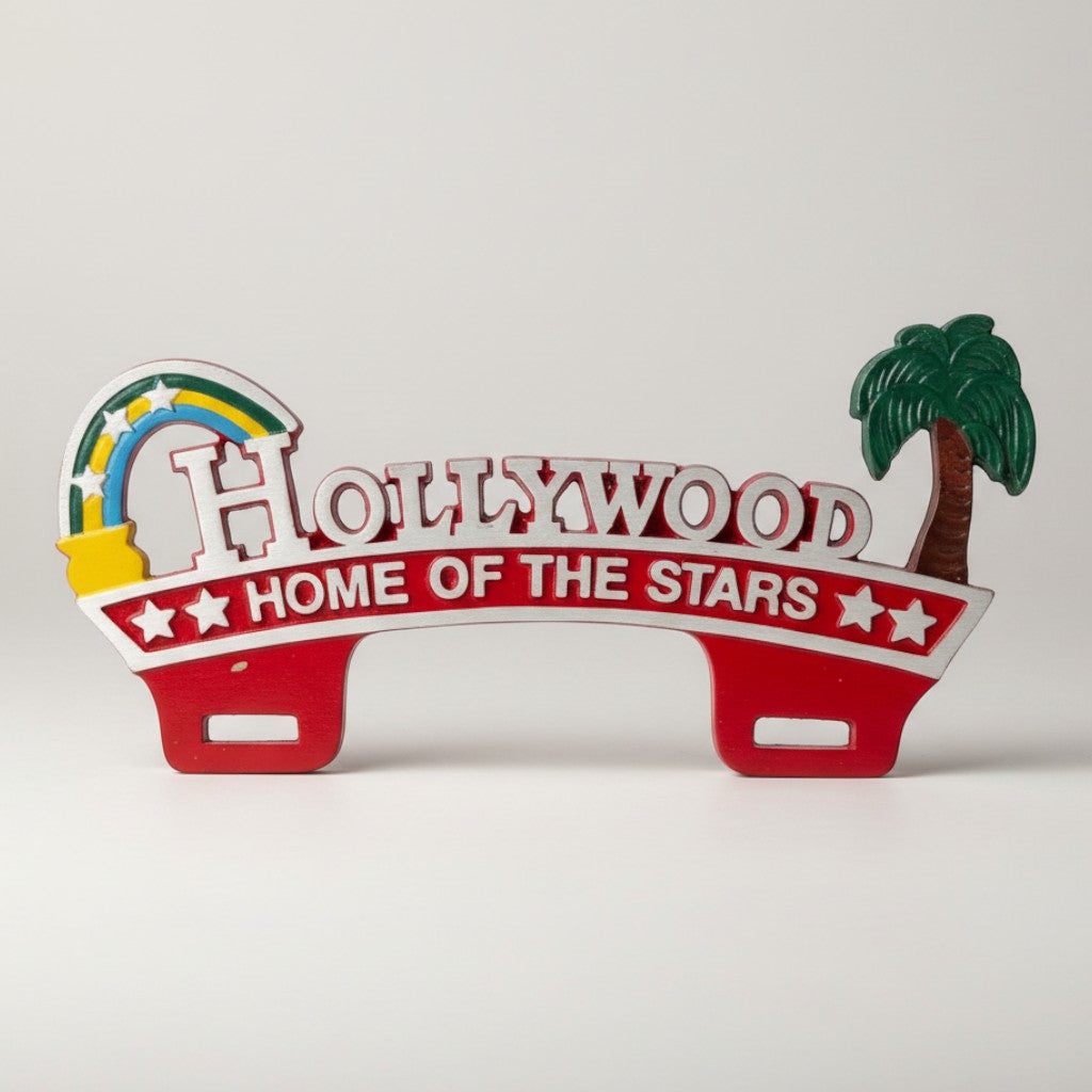 Jones Peak Hollywood Home of the Stars license plate topper, red with white lettering, rainbow, and palm tree. Hardwood.