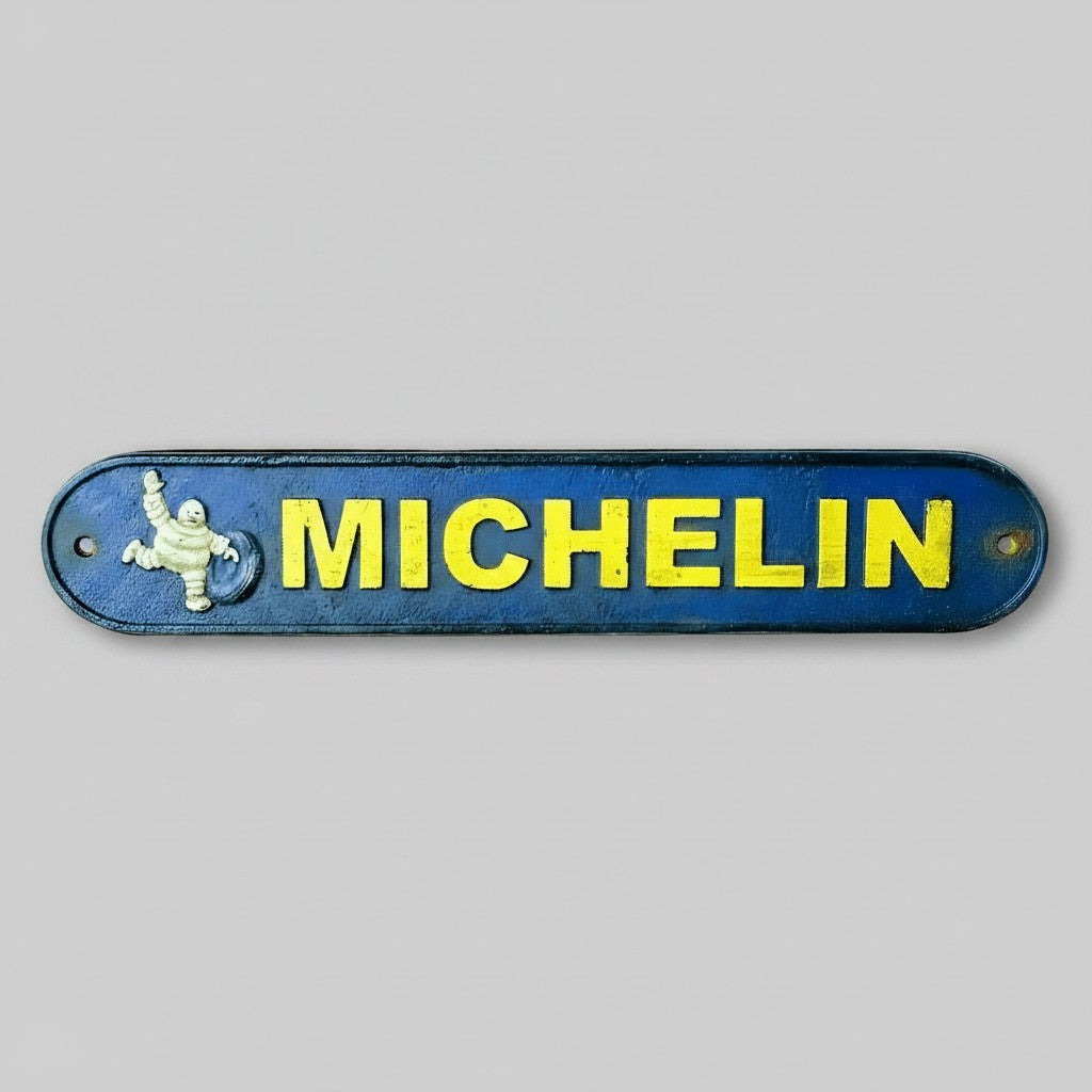 Jones Peak Michelin Man cast iron plaque with antique blue and yellow finish for vintage garage wall decor.