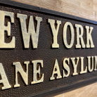 Jones Peak New York Insane Asylum cast iron plaque with raised cream lettering and antique patina finish.
