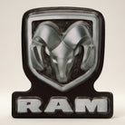 Jones Peak Ram embossed metal magnet with silver ram head and black background. Features "RAM" text.