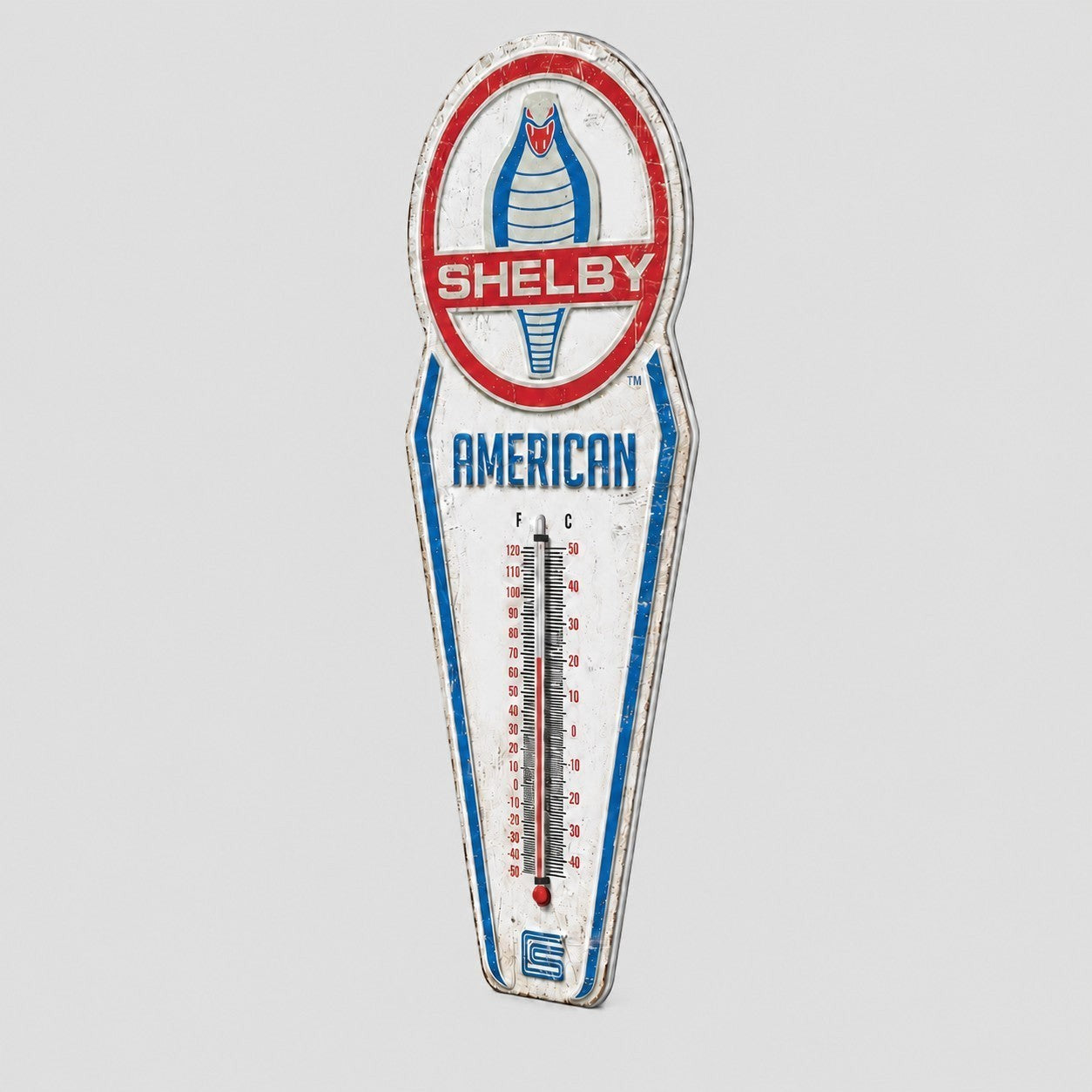 Jones Peak Shelby American embossed metal thermometer with vintage cobra logo and distressed finish for wall decor.