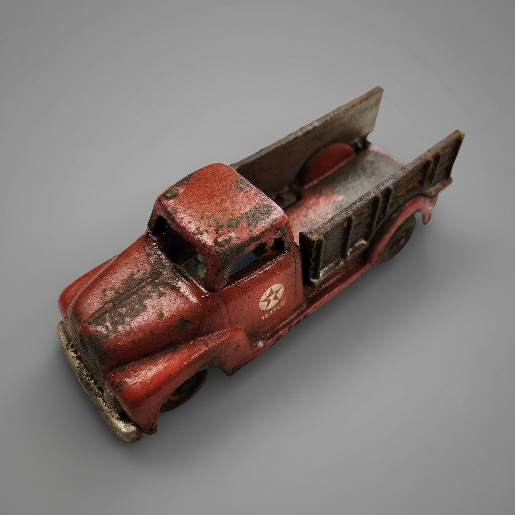 Jones Peak vintage-style red cast iron Texaco toy truck with a distressed antique finish and moving wheels.