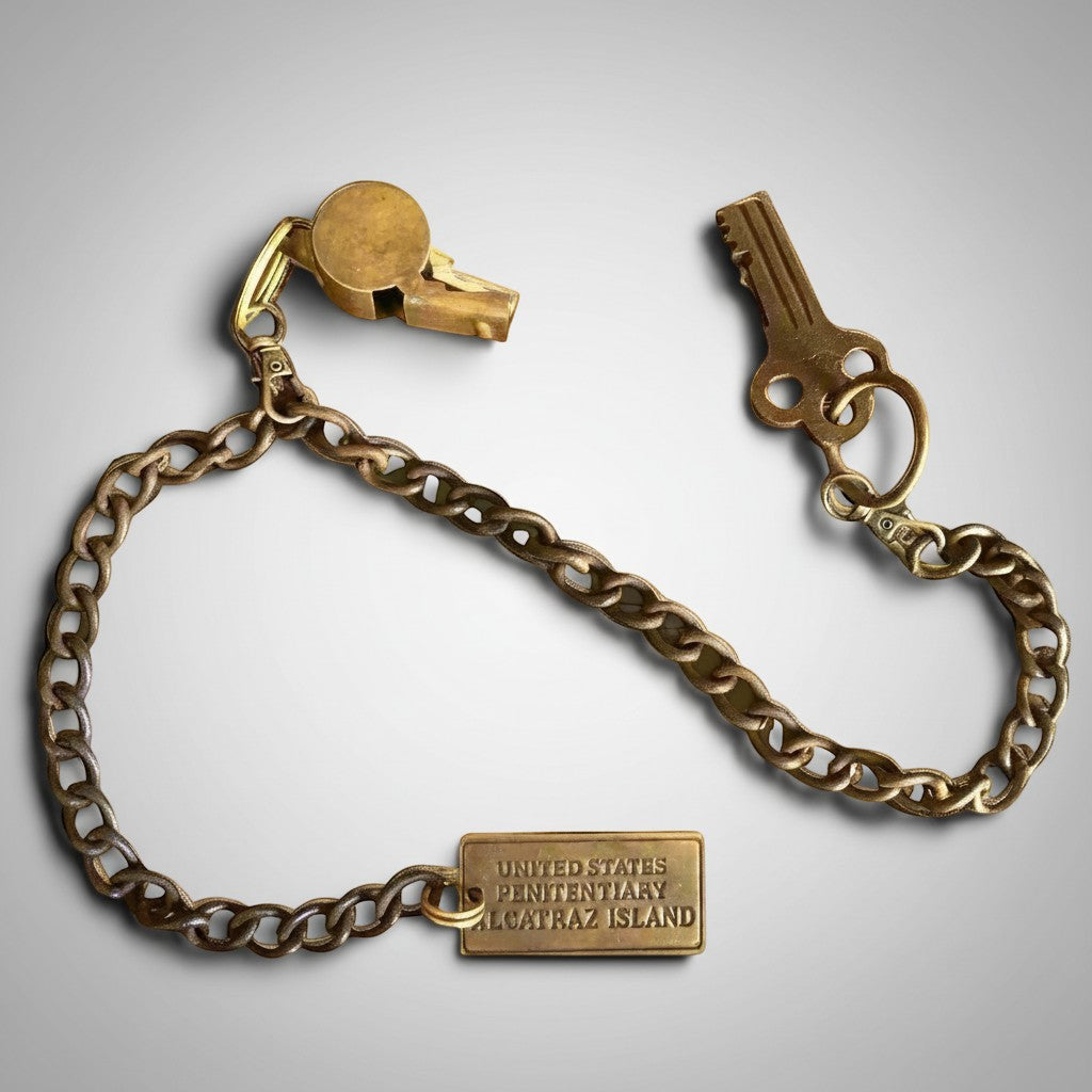 Jones Peak Alcatraz prison guard key, tag, and brass whistle set with a long chain and antiqued patina.