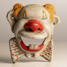 Jones Peak clown cast iron wall bottle opener with red nose, red polka dot bow tie, and yellow hair.