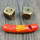 Jones Peak red plastic hot dog novelty whistle with Oscar Mayer logo and two brass dice.