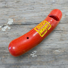 Jones Peak red plastic hot dog novelty whistle with yellow Oscar Mayer logo, 2 inches long.