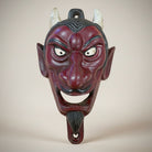 Jones Peak red cast iron devil face wall bottle opener with white horns and black accents.