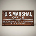Jones Peak U.S. Marshal Office Deadwood Dakota Territory cast iron plaque with raised white lettering and antique patina finish.