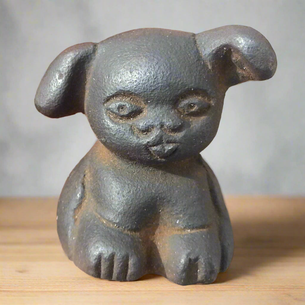 Great Western Griswold pup paperweight in cast iron, featuring raised letters and an antique finish, 1.5 inches tall.