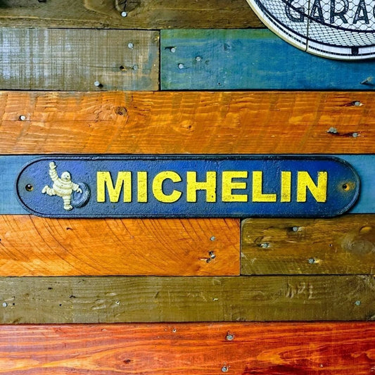 Tire Man Cast Iron Plaque With A Distressed Antique Hand Painted Finish (19.5" x 3.5") - Jones Peak