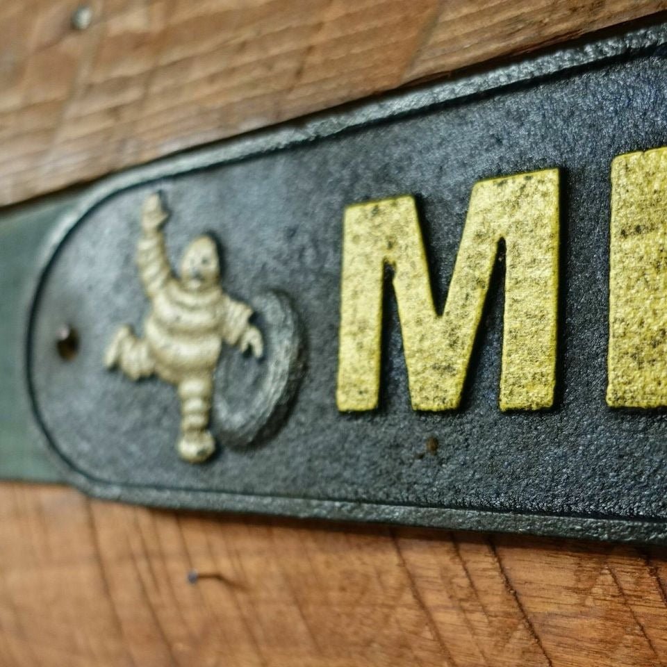 Tire Man Cast Iron Plaque With A Distressed Antique Hand Painted Finish (19.5" x 3.5") - Jones Peak