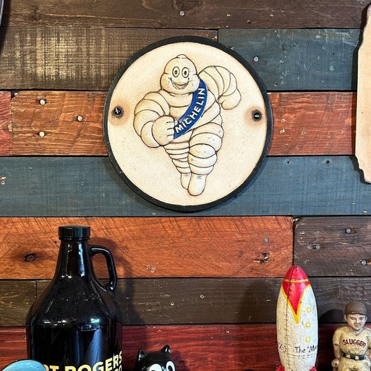 Tire Man Cast Iron Plaque With Painted Antique Finish (9.5 Round) - Jones Peak